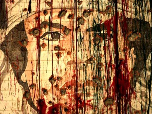 A defaced portrait of fugitive Libyan leader Muammar Gaddafi is pictured in Tripoli. Libya marks the first anniversary of revolutionary uprising against Muammar Gaddafi. AFP/Patrick Baz, File
