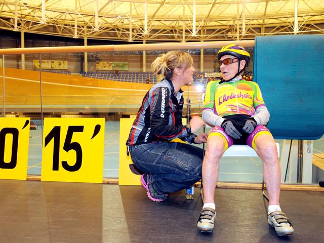 French cycling enthusiast and centenarian Robert Marchand (R) speaks with his coach Magali Humbert after setting a new record in the Master 100 years category on the track of the International Union Cycling in Aigle. AFP Photo/Sebastien Feval