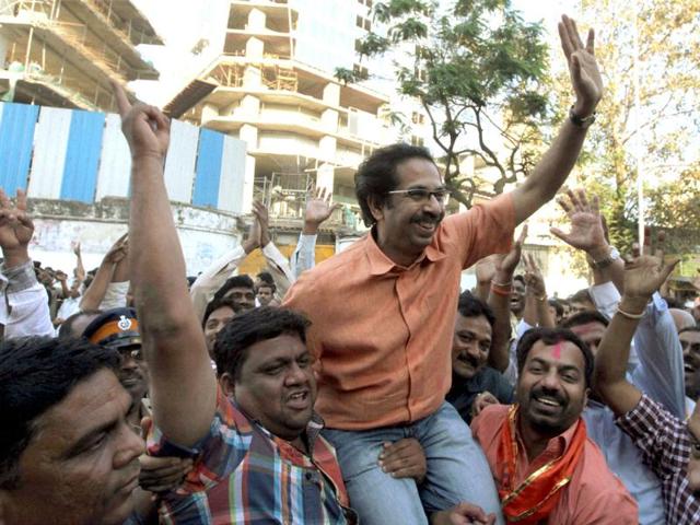 Shiv Sena executive president Uddhav Thackeray with party workers celebrate their win in the corporation elections near Sena Bhavan in Mumbai. PTI/Santosh Hirlekar
