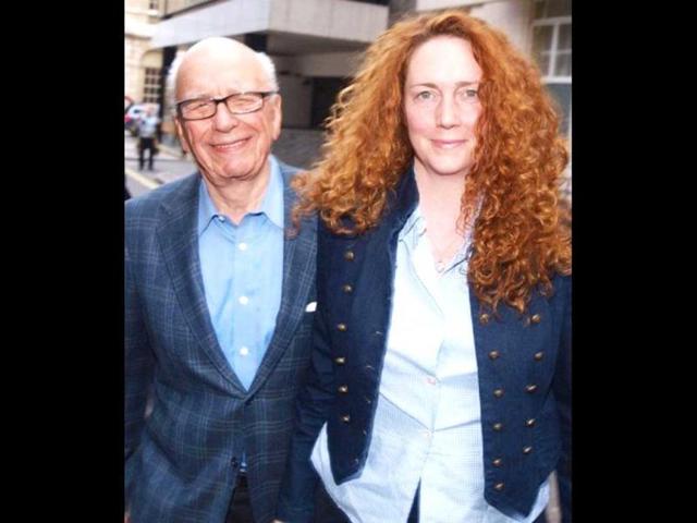 Rebekah Brooks (R) Chief Executive of News International and Rupert Murdoch Chairman of News Corporation leave from his London residence shortly after his arrival in Britain. AFP Photo/ Max Nash
