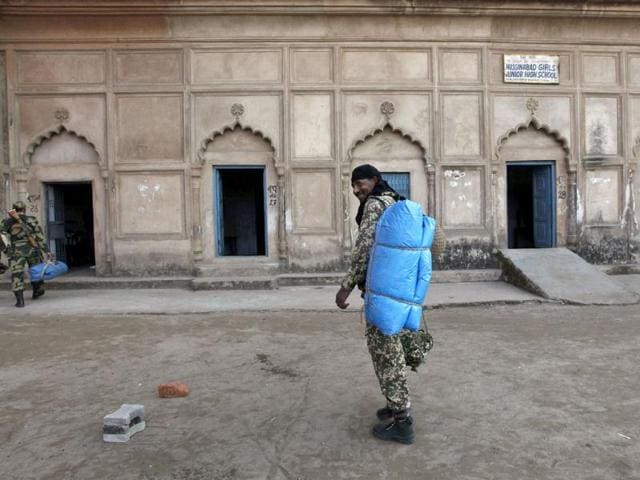 Paramilitary soldiers arrive with luggage at their assigned polling station for election duty in Lucknow. AP/Rajesh Kumar Singh