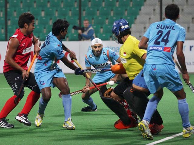 Indian Hockey team players make a move against Singapore during the Hero FIH Road to London Delhi 2012, at National Stadium in New Delhi. HT/Ajay Aggarwal