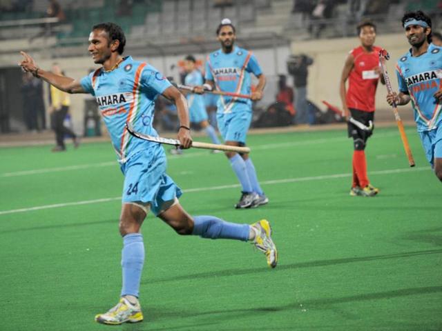 Sunil Sowmarpet Vitalacharya of India (L) celebrates his goal against Singapore during the men's field hockey match of the FIH London 2012 Olympic Hockey qualifying tournament at the Major Dhyan Chand National Stadium in New Delhi. AFP/Indranil Mukherjee