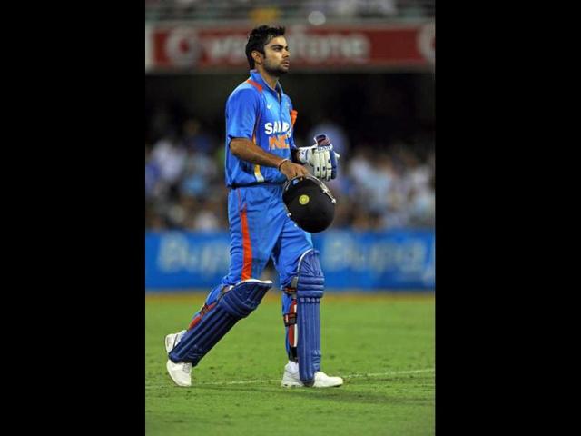 Virat Kohli leaves the field after being dismissed following a third umpire decision during their one-day international cricket match against Australia in Brisbane. AFP Photo/Greg Wood.