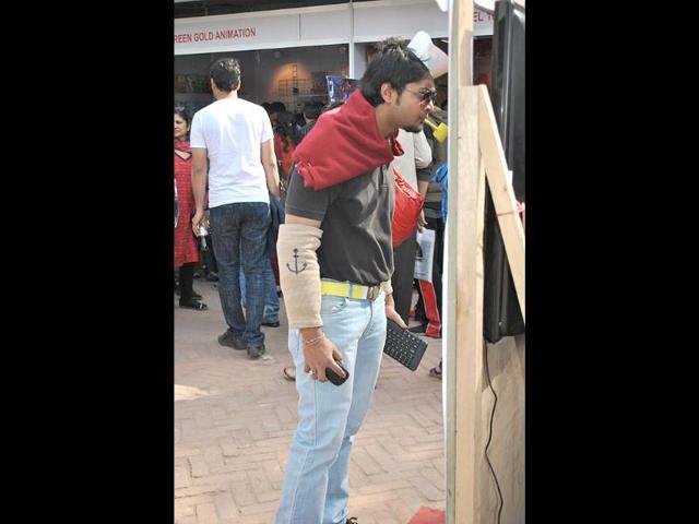 A man dressed as cartoon character Popeye looks into a TV screen during the 2nd annual Indian Comic Con in Delhi. HT/Divya Jain