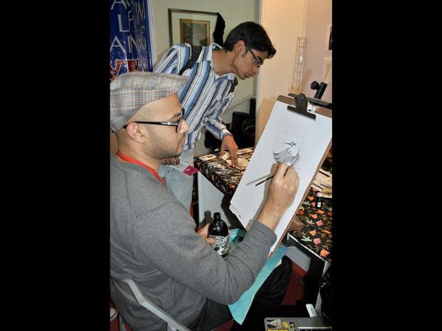 An artist sketches during the 2nd annual Indian Comic Con in Delhi. HT/Divya Jain