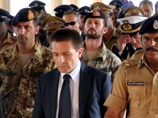 An-Italian-diplomat-C-walks-in-front-of-two-Italian-guards-second-row-L-and-2nd-L-of-the-oil-tanker-Enrica-Lexie-as-they-were-taken-into-custody-in-Cochin-Indian-police-took-two-Italian-security-guards-into-custody-on-February-19-after-two-fishermen-were-allegedly-mistaken-for-pirates-and-shot-dead-from-an-Italian-oil-tanker-AFP-PHOTOcaptain-of-the-ship