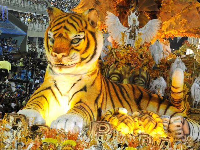 Revelers of the Porto da Pedra samba school performs atop of a float at the Sambadrome, during the first night of carnival celebrations in Rio de Janeiro. AFP PHOTO / VANDERLEI ALMEIDA