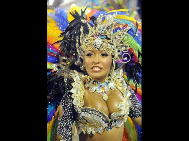 A reveller of Beija-Flor samba school performs during the first night of carnival parade at the Sambadrome in Rio de Janeiro.