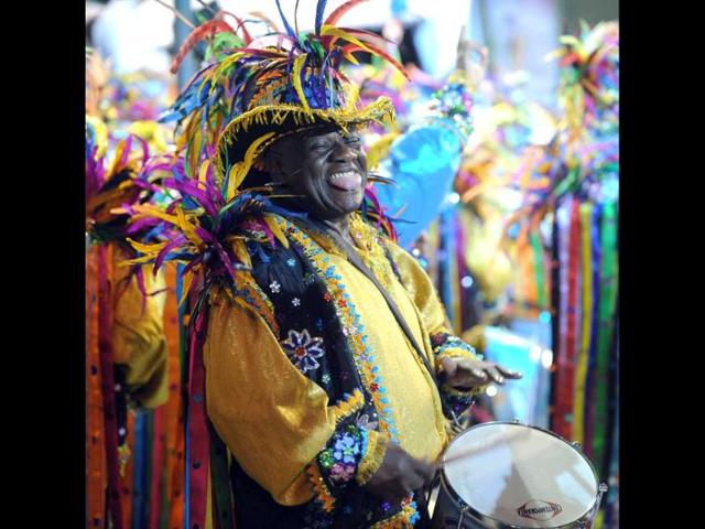 A drummer of Beija-Flor samba school performs during the first night of carnival parade at the Sambadrome in Rio de Janeiro. AFP PHOTO / ANTONIO SCORZA