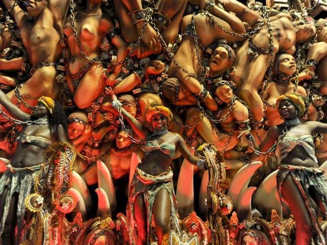 Revellers of Beija-Flor samba school dance on a float during the first night of carnival parade at the Sambadrome in Rio de Janeiro.AFP PHOTO / ANTONIO SCORZA
