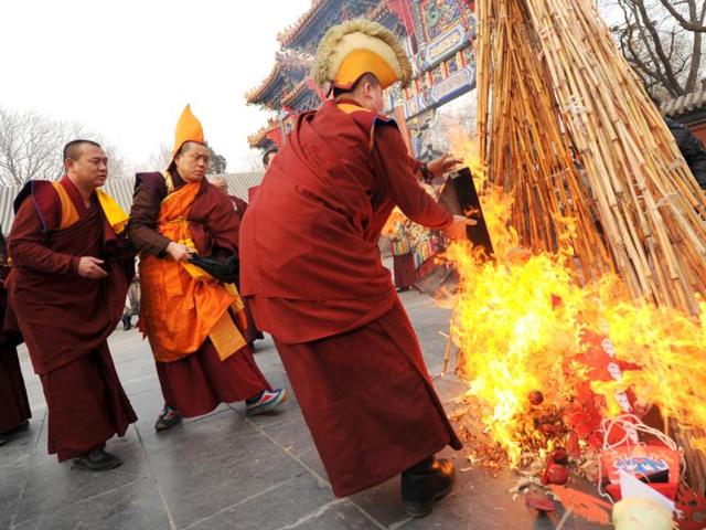 Tibetan monks throw a skull effigy into flames during a Tibetan New Year ceremony at the Yonghe Temple, also known as the Lama Temple in Beijing. AFP Photo/Mark Ralston