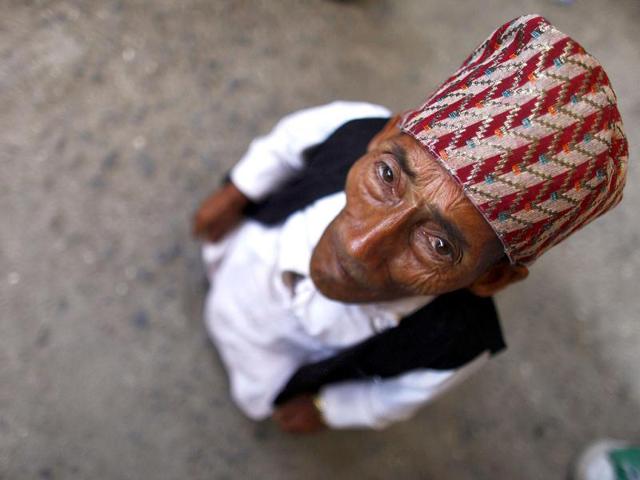 Chandra Bahadur Dangi, 72, who says he's only 22 inches (56 centimeters) tall arrives at the airport in Katmandu, Nepal. Guinness World Records officials will be in Nepal this weekend to measure Dangi who hopes to be named the world's shortest man. Dangi is hoping to snatch the title of the world's shortest man from Junrey Balawing of the Philippines, who is 23.5 inches (60 centimeters) tall. AP Photo/Niranjan Shrestha