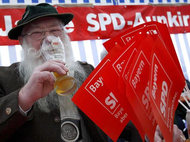 Hans Baumgartner, in traditional Bavarian clothes, drinks beer during the traditional Ash Wednesday meeting of the SPD in Vilshofen, southern Germany. (Reuters/Michaela Rehle)