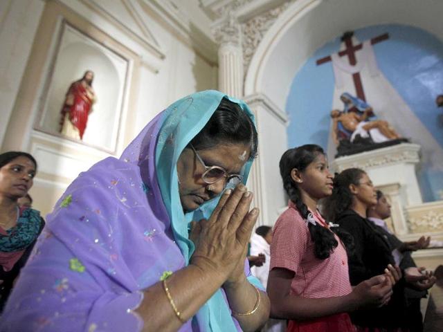 A woman, her forehead marked with ash in the symbol of the crucifix, attends a mass in observance of Ash Wednesday at a Catholic church in Hyderabad. (AP Photo/Mahesh Kumar A.)