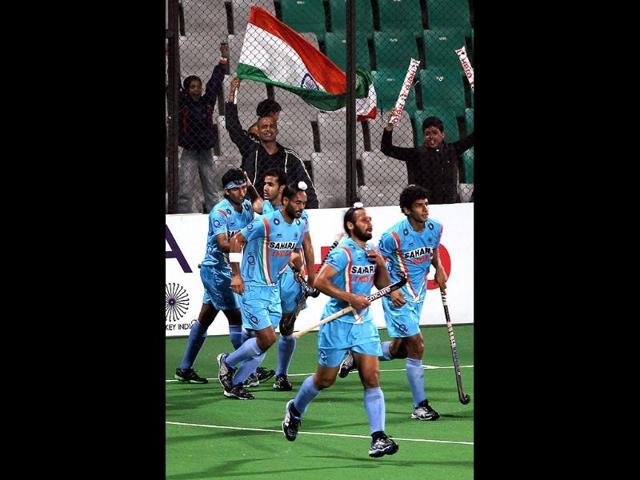 Shivendra Singh celebrates with his teammates after scoring a goal against Canada during their Olympic qualifier match, in New Delhi. PTI Photo by Manvender Vashist
