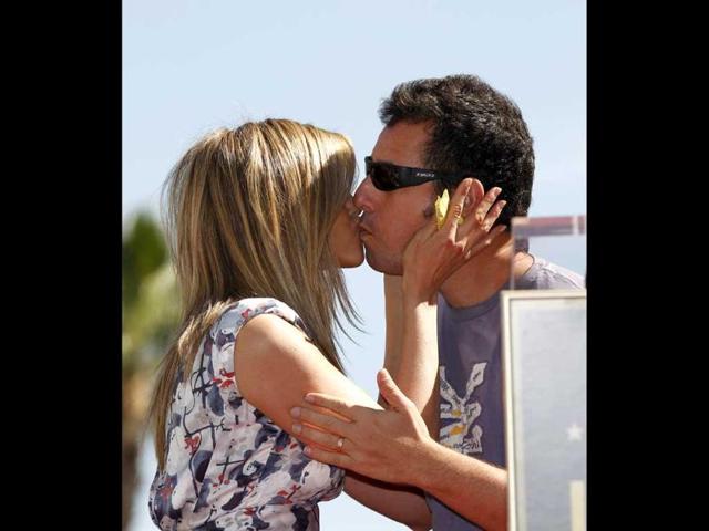 Actors Jennifer Aniston and Adam Sandler greet each other before the unveiling of her star on the Walk of Fame in Hollywood, California. Reuters/Mario Anzuoni