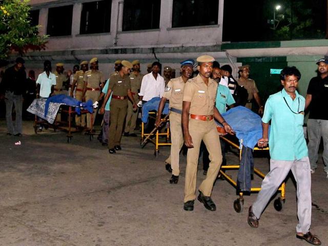 Police take away the bodies of bank robbers after an encounter near Velachery in Chennai. PTI/R Senthil Kumar
