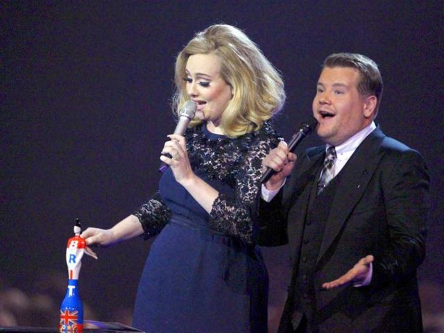 Adele sings after getting the award on stage.
