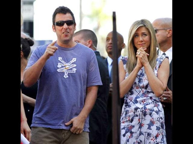 Aniston stands next to actor Adam Sandler before unveiling her star on the Walk of Fame.