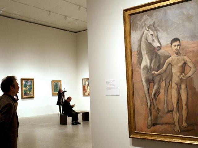 A man looks at Pablo Picasso's 'Boy Leading a Horse' during the preview of 'The Steins Collect: Matisse, Picasso, and the Parisian Avant-Garde' at the Metropolitan Museum of Art in New York City. Spencer Platt/Getty Images/AFP