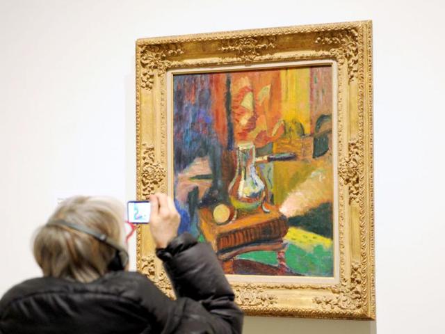 A woman takes a photograph of 'Still Life with Chocolate Pot' 1900-1902 by Henri Matisse during a preview of 'The Steins Collect: Matisse, Picasso, and the Parisian Avant-Garde' at the Metropolitan Museum of Art in New York. AFP/Stan Honda