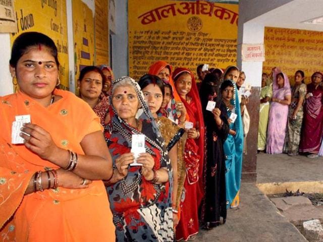 Voters standing in a queue to cast their votes during the fifth phase of UP assembly polls in Jhansi . PTI Photo