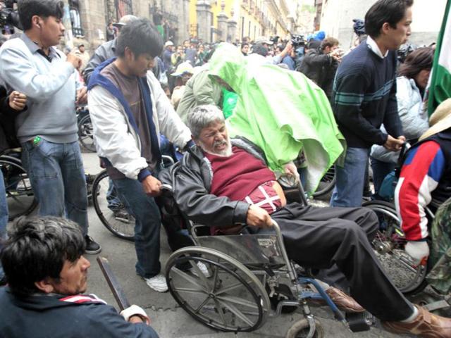 Physically disabled people gather in La Paz. Hundreds of physically disabled people arrived in La Paz after completing a protest march of some 1600 km (994 miles) over a hundred days to demand that Bolivia's government offer support in the form of 3000 bolivianos ($434) payment to each physically disabled Bolivian, according to local media. Reuters/David Mercado