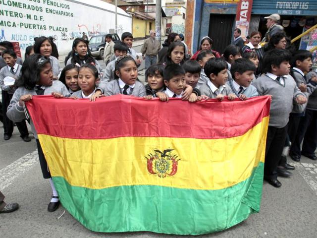 Bolivian school students hold their national flag in support of physically disabled people who completed their protest march in La Paz. Hundreds of physically disabled people arrived in La Paz on Thursday after completing a protest march of some 1600 km (994 miles) over a hundred days to demand that Bolivia's government offer support in the form of 3000 bolivianos ($434) payment to each physically disabled Bolivian, according to local media. Reuters/David Mercado
