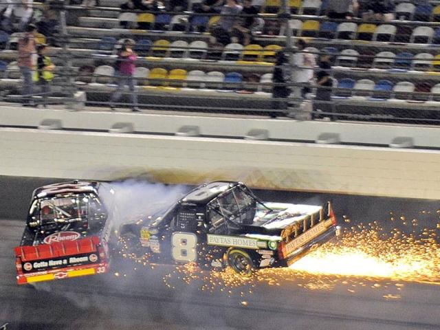 Clay Greenfield in his number 68 Ford (L) and Mike Skinner in his number 8 Chevrolet collide during the NASCAR Camping World Series NextEra Energy Resources 250 truck race at the Daytona International Speedway in Daytona Beach, Florida. (Reuters)