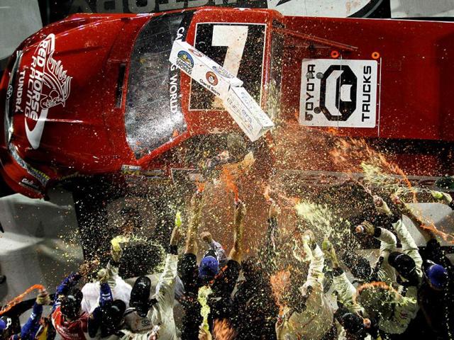 John King, driver of the #7 Red Horse Racing Toyota, celebrates with his team in Victory Lane after winning the NASCAR Camping World Truck Series NextEra Energy Resources 250 at Daytona International Speedway on February 24, 2012 in Daytona Beach, Florida. (AFP Photo)