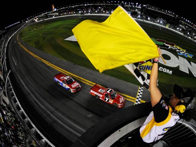 John King, driver of the #7 Red Horse Racing Toyota, takes the checkered flag under caution to win the NASCAR Camping World Truck Series NextEra Energy Resources 250 at Daytona International Speedway in Daytona Beach, Florida. (AFP Photo)