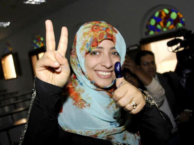 Nobel Peace Prize laureate Tawakul Karman shows her inked thumb after casting her vote at a polling station in Sanaa. Yemen sealed President Ali Abdullah Saleh's exit from power on Tuesday by electing his deputy, Vice President Abd-Rabbu Mansour Hadi, to shepherd the country away from the brink of civil war. Reuters/Stringer