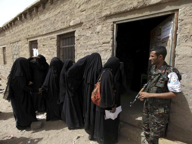 A policeman organizes female voters during presidential elections in Sanaa. Yemen sealed President Ali Abdullah Saleh's exit from power by electing his deputy, Vice President Abd-Rabbu Mansour Hadi, to shepherd the country away from the brink of civil war. Reuters/Mohamed al-Sayaghi