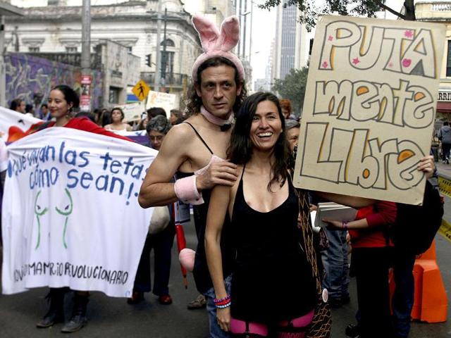 Members of the Network of Women take part in a 'March of the whores' to protest against discrimination and violence against women in Bogota. The poster reads: Free whore mind. REUTERS/Fredy Builes