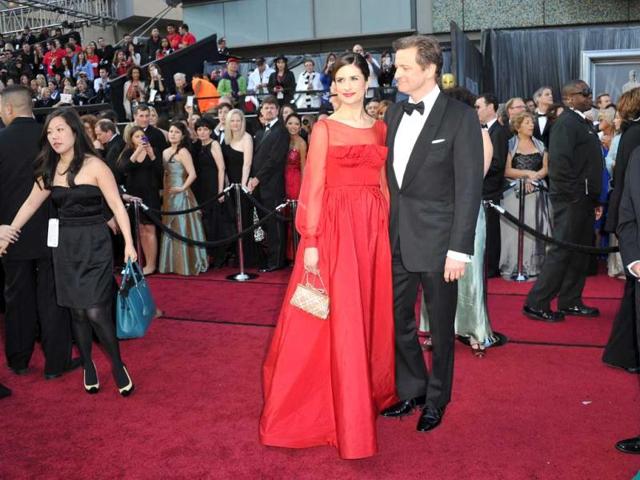Actor Colin Firth (R) and Livia Giuggioli arrive on the red carpet for the 84th Annual Academy Awards. (AFP)