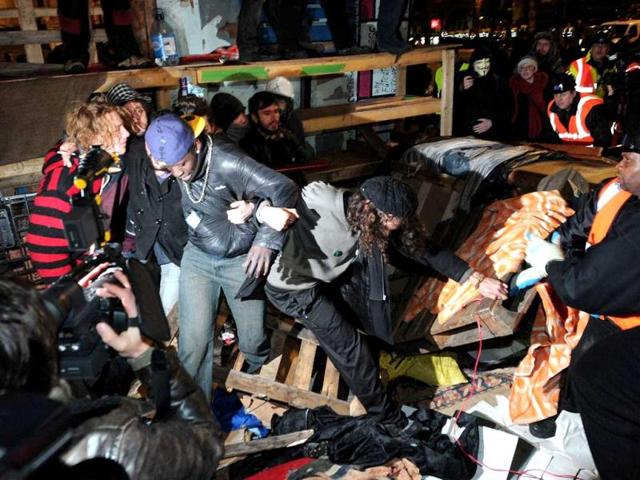 Protesters stand in front of a makeshift barricade at the Occupy protest camp outside Saint Paul's Cathedral in central London. (AFP photo/Carl Court)