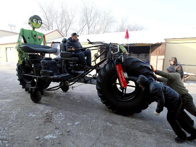 Zhang Yali, 49, tests a giant bicycle designed and made by him and his friends outside a rented warehouse in Jilin, Jilin province. The 3.2-metre-high and 5.5-metre-long three-seated giant bicycle, weighing over one tonne, cost Zhang more over 20,000 yuan (3,156 $). Zhang spent two months making this bike as a gift for his son, a 25-year-old part-time cartoonist currently living in Shenzhen, Guangdong province. According to Zhang's family, they were planning to ride this bike from Jilin to Shenzhen, local media reported. Reuters/China Daily