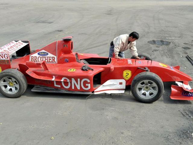 Zhao Xiushun checks a homemade vehicle he claims is modelled after a Formula One car in Tangshan, Hebei Province. Zhao and his elder brother Zhao Xiushun built the car from scrap metal and said that they wanted to design and build the first Formula One race car in China. The car is 3.1-metre (10.2 feet) in length, 1.25-metre (4.1 feet) in width and 1.1-metre (3.6) in height and can reach maximum speed of 60 km per hour (37 miles per hour). Reuters/Stringer.