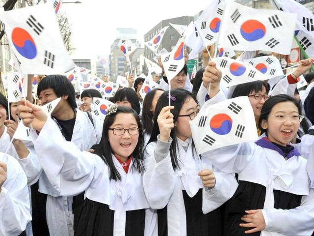 South Koreans wearing traditional costumes wave national flags as they march during the celebration of Independence Movement Day in Seoul. South Koreans celebrated the public holiday to mark the 1919 civilian uprising against Japanese rule, that colonized the Korean peninsula from 1910-1945. AFP Photo/Jung Yeon-Je