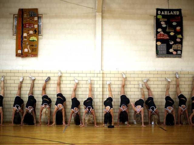 This photo won second place (picture story/sports) in the White House News Photographers Association (WHNPA) 2012 contest. Baltimore Ravens cheerleaders work out during cheerleader training camp at Deep Creek, Maryland, May 20, 2011. Reuters/Jason Reed
