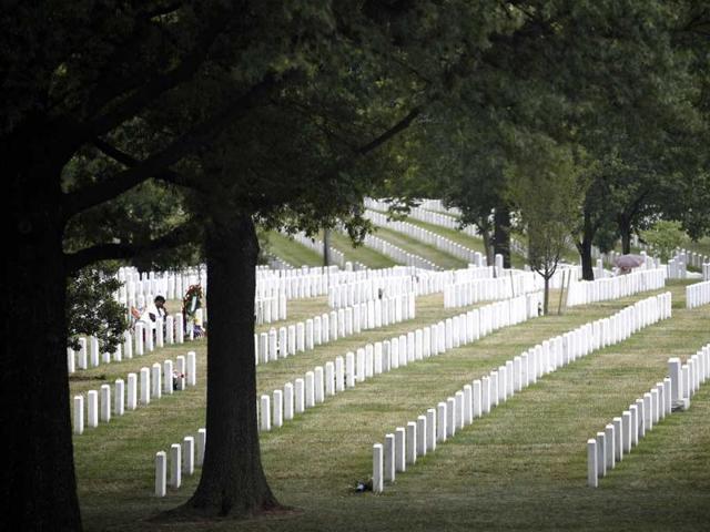 This photo won third place (picture story/feature) in the White House News Photographers Association (WHNPA) 2012 contest. Paula Davis (L), mother of fallen US Army Private Justin Ray Davis, sits alone at his grave alongside hundreds of others in Section 60 of Arlington National Cemetery June 25, 2011. Reuters/Jason Reed/Jason Reed