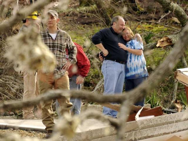 Jim and Jennie Hood embrace after a tornado hit and completely tore down their home on Short Tail Springs Rd. in Harrison, Tennesse. Powerful storms stretching from the Gulf Coast to the Great Lakes flattened buildings in several states, wrecked two Indiana towns and bred anxiety across a wide swath of the country in the second powerful tornado outbreak this week. (AP Photo/Chattanooga Times Free Press, Ashlee Culverhouse)