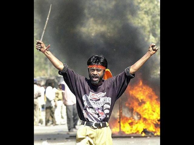 This-file-photograph-taken-February-28-2002-shows-a-Bajrang-Dal-activist-armed-with-an-iron-stick-shouting-slogans-against-Muslims-as-they-went-burning-Muslim-shops-and-attacked-residences-at-Sahapur-in-Ahmedabad-AFP-photo-Sebastian-D-Souza-Files This-file-photograph-taken-February-28-2002-shows-a-Bajrang-Dal-activist-armed-with-an-iron-stick-shouting-slogans-against-Muslims-as-they-went-burning-Muslim-shops-and-attacked-residences-at-Sahapur-in-Ahmedabad-AFP-photo-Sebastian-D-Souza-Files