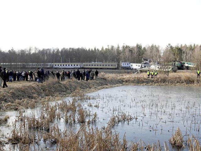 Onlookers gather at the site of a train crash near the town of Szczekociny. At least 15 people were killed when two passenger trains collided head-on in southern Poland late on Saturday in one of the country's worst train crashes in more than 20 years. The two trains carrying an estimated 350 passengers were heading in opposite directions on the same track when they crashed at high speed in a rural area near the town of Szczekociny. (Reuters)