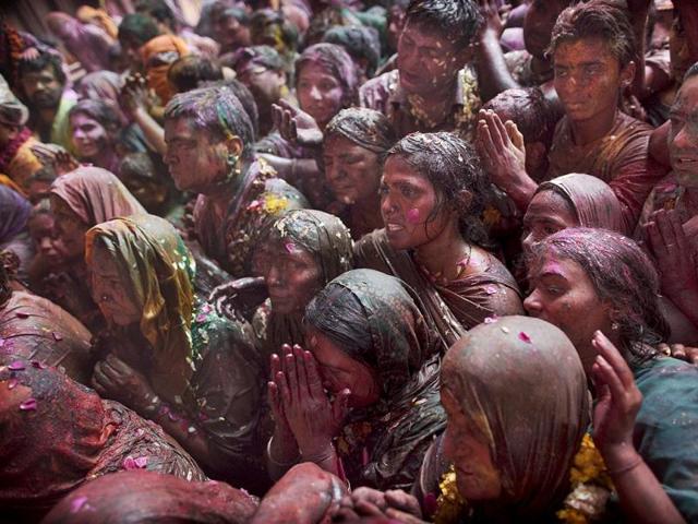 Devotees crowd as they look at a deity of Lord Krishna while celebrating Holi, the festival of color, at the Banke Bihari temple in Vrindavan. AP Photo/Kevin Frayer