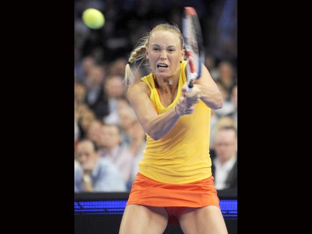 Caroline Wozniacki returns the ball to Maria Sharapova during the BNP Paribas Showdown exhibition tennis match, at Madison Square Garden in New York. (AP Photo/Bill Kostroun)