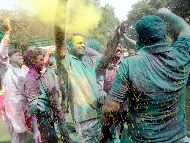 People throw coloured powder on each other during Holi celebrations in New Delhi. AFP Photo/Raveendran