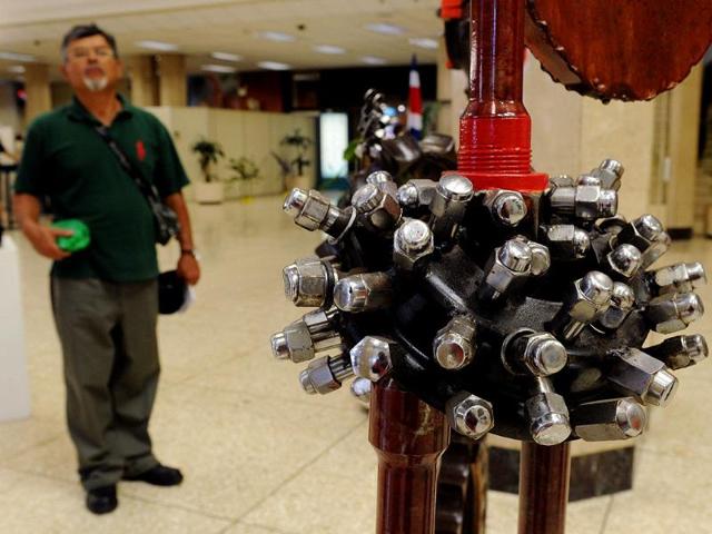A visitor watches Henry Chacon's sculpture "Color Season", part of the exhibition by Costa Rican artists held at the National Gallery in San Jose on March 7, 2012. The exhibition is part of the "Museums and Galleries Route" during the XIII International Arts Festival to be held in San Jose from 1 to 25 March. (AFP Photo)