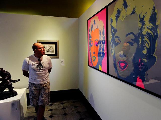 A visitor stands beside Andy Warhol's "Marlyn" at the National Gallery in San Jose on March 7, 2012. The exhibition is part of the "Museums and Galleries Route" during the XIII International Arts Festival to be held in San Jose from 1 to 25 iMarch. (AFP Photo)